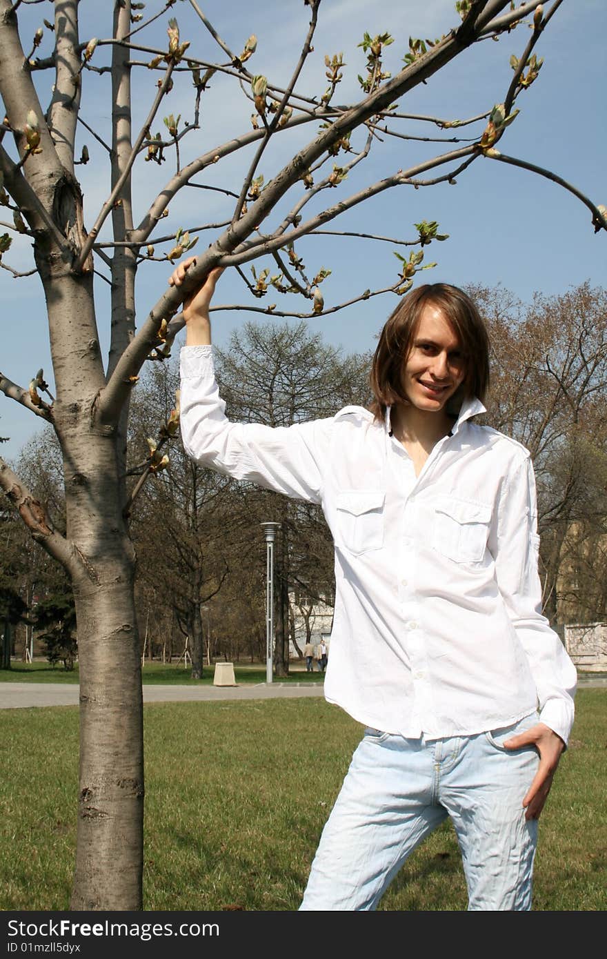 Man standing near a tree