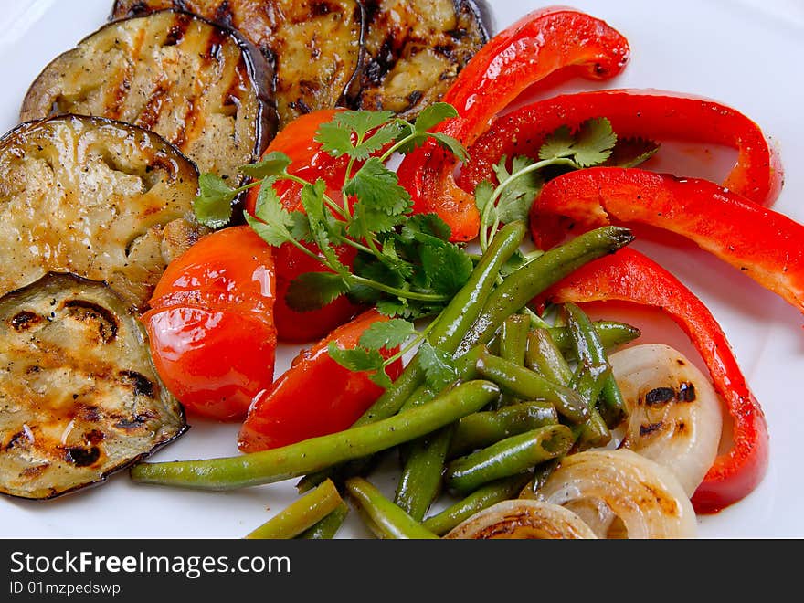 Baked eggplant with pepper, tomato and asparagus on a plate. Baked eggplant with pepper, tomato and asparagus on a plate