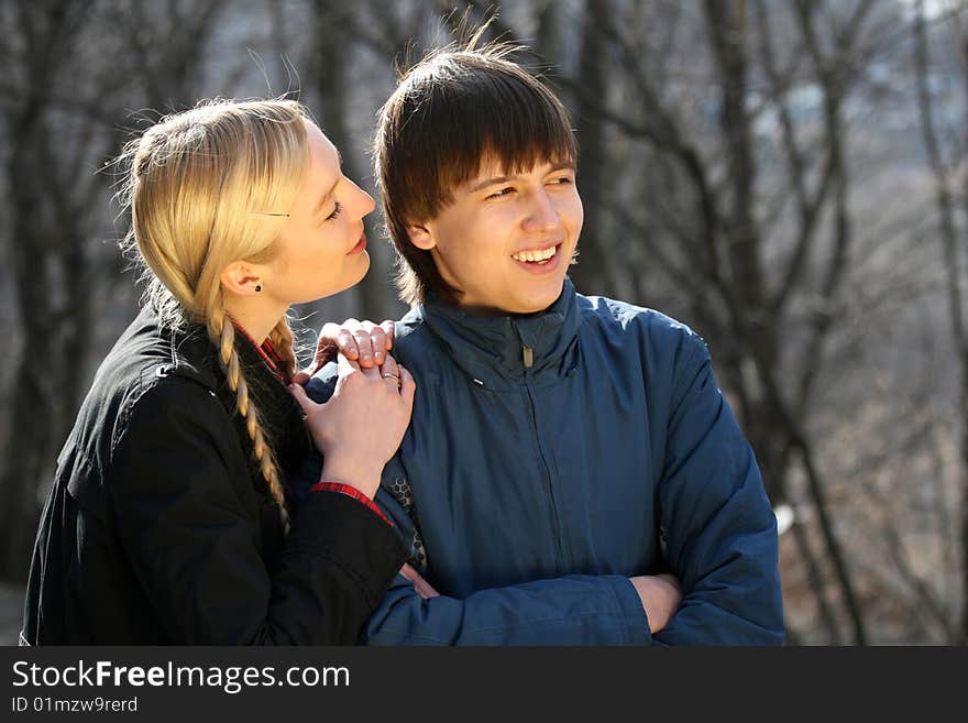 Two young teenagers talking in the park