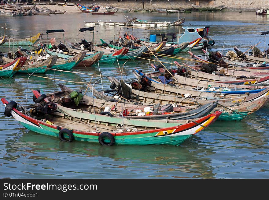 Chinese fishing boats tied together and lined-up. Chinese fishing boats tied together and lined-up