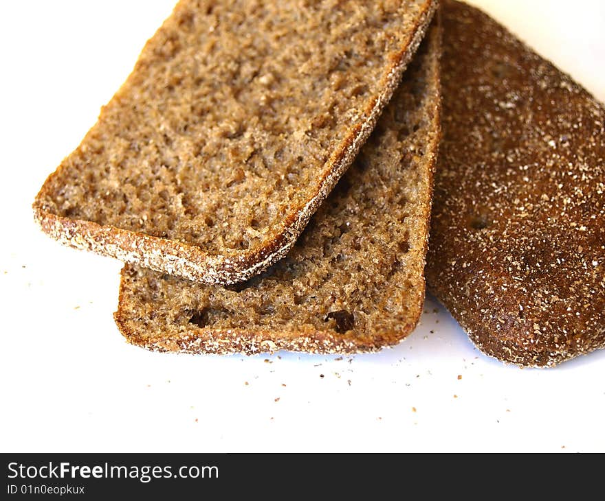 Three slices of rye bread on white background