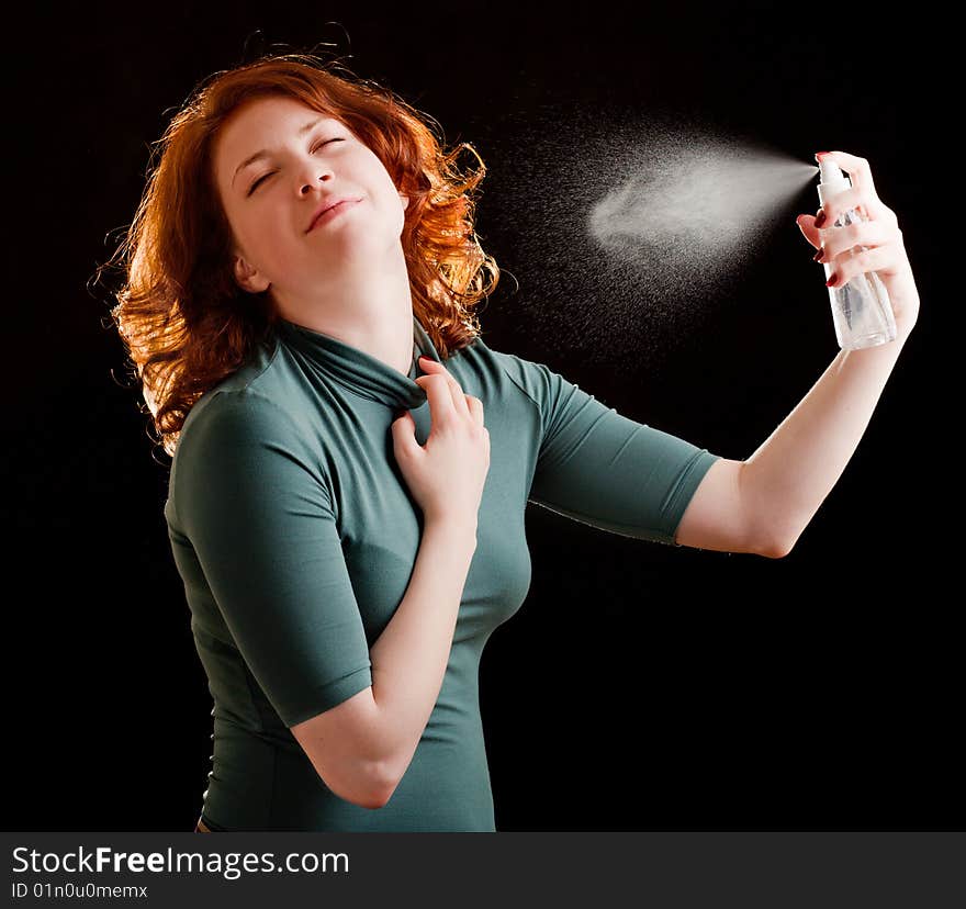 Girl with red hair holding a spray. Girl with red hair holding a spray