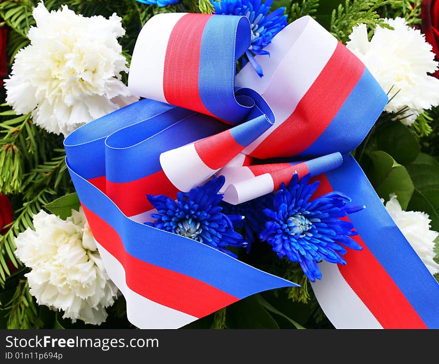 Memorial wreath with red, blue and white tricolor and flowers