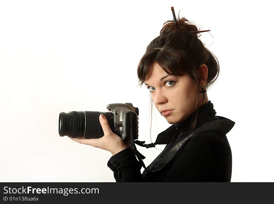 The beautiful girl with a camera on a white background