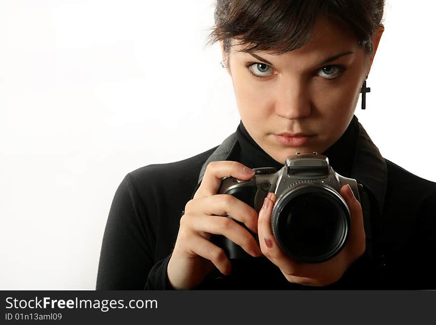 The beautiful girl with a camera on a white background