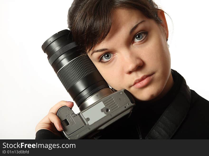 The beautiful girl with a camera on a white background