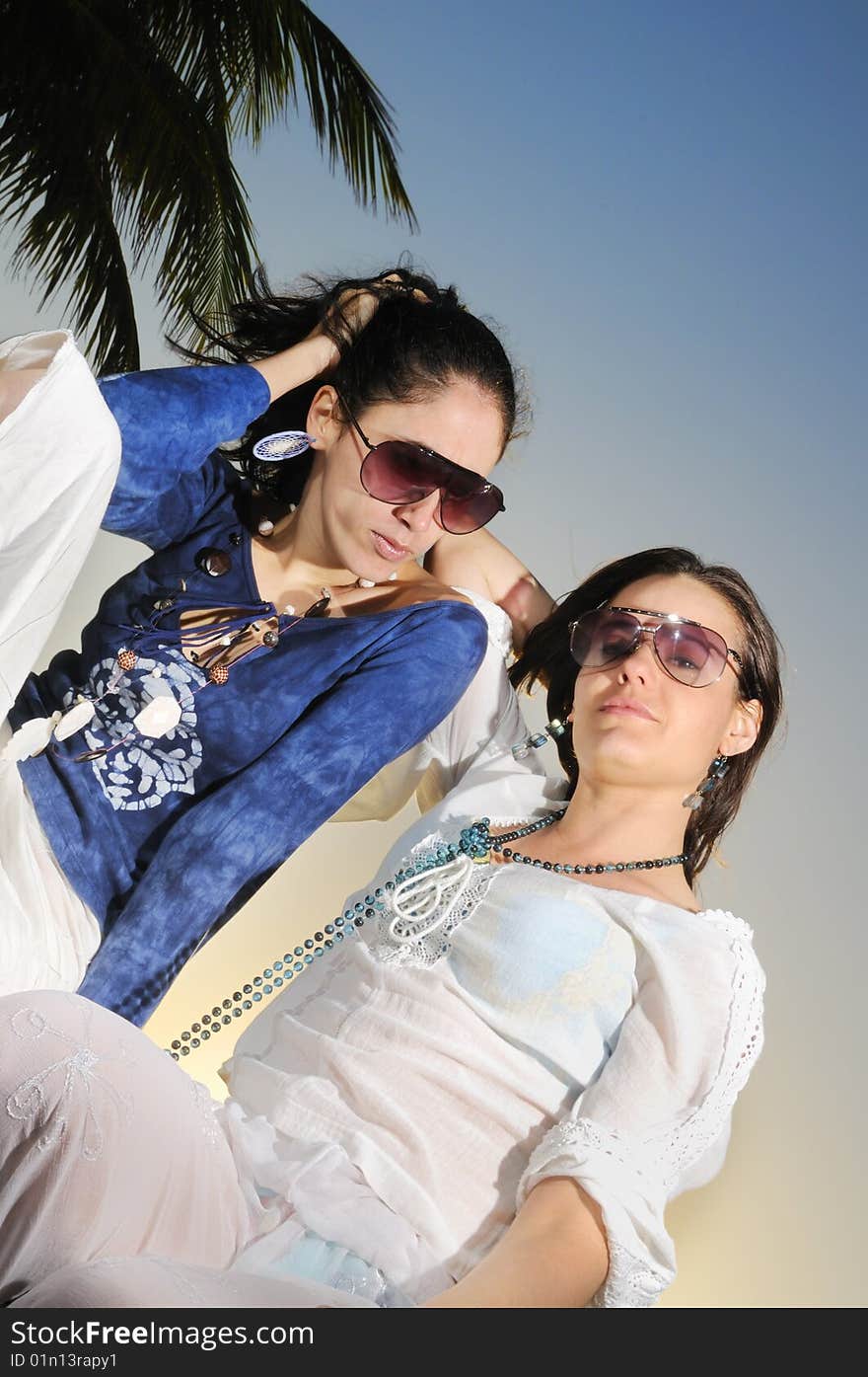 Portrait of two fashion female models on tropical beach. Portrait of two fashion female models on tropical beach