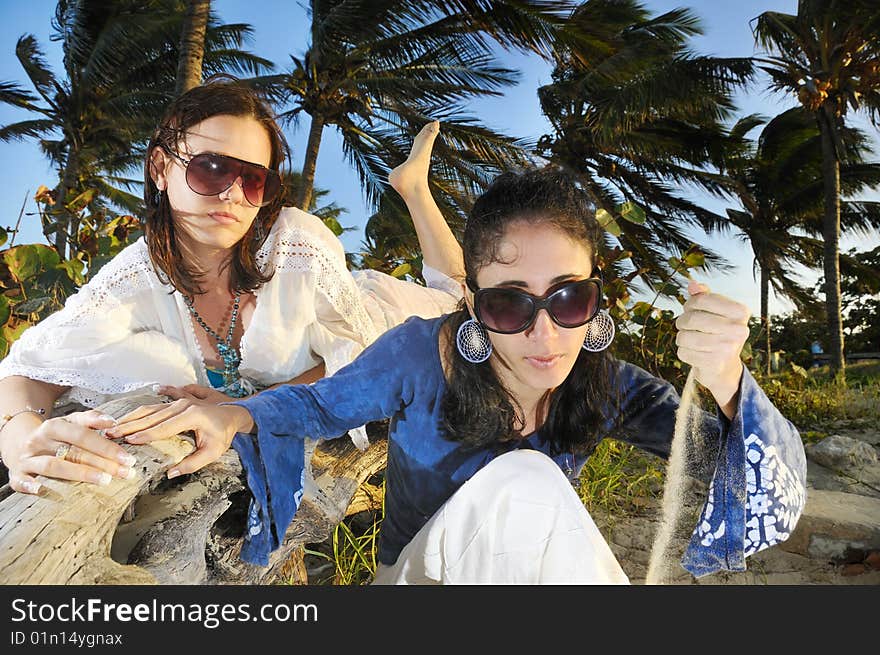 Portrait of two fashion female models on tropical beach. Portrait of two fashion female models on tropical beach