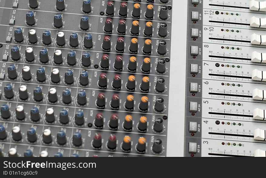 Knobs and sliders of a sound mixer