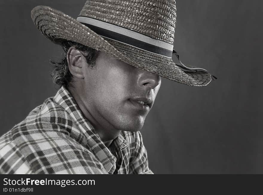 Portrait of young rude man wearing cowboy hat