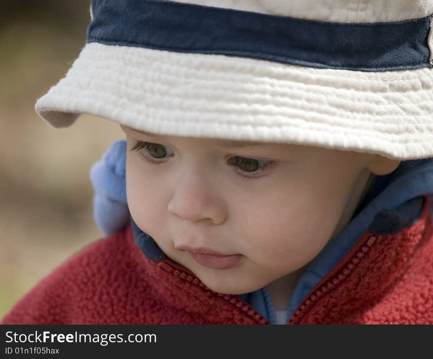 Young boy lost in is mind during a trip in nature. Young boy lost in is mind during a trip in nature