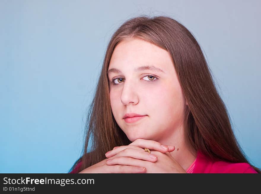 Teenage girl posing over blue background. Teenage girl posing over blue background