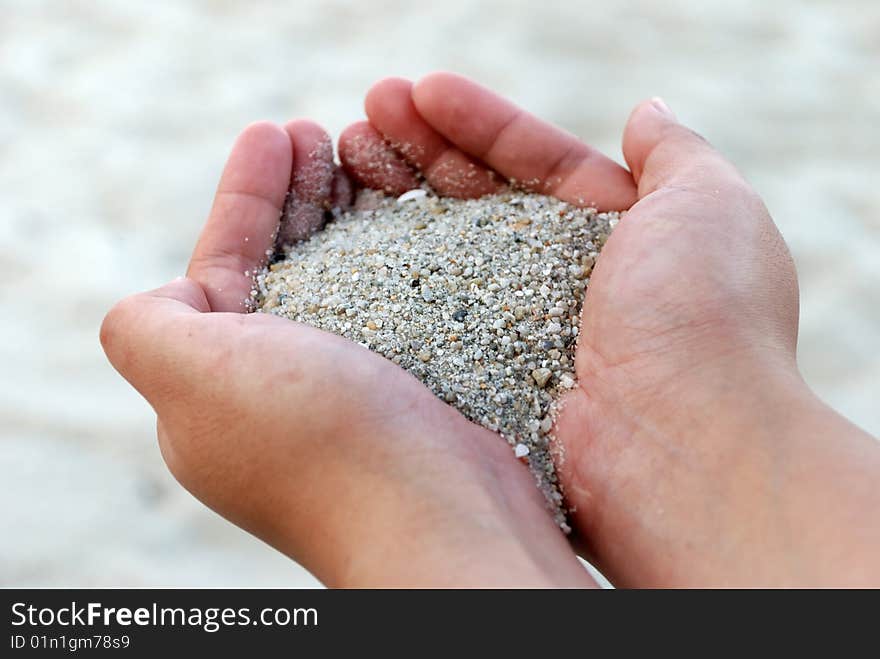 Close capture on beach sands falling from hand. Close capture on beach sands falling from hand