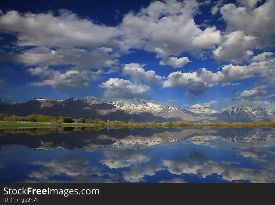 Rocky Mountains in the spring showing trees and snow capped mountains with
Refelections in a lake. Rocky Mountains in the spring showing trees and snow capped mountains with
Refelections in a lake