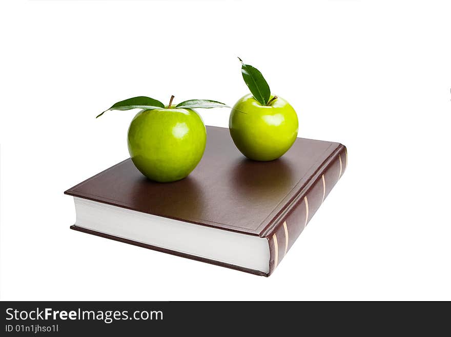 Book and green apples. White background