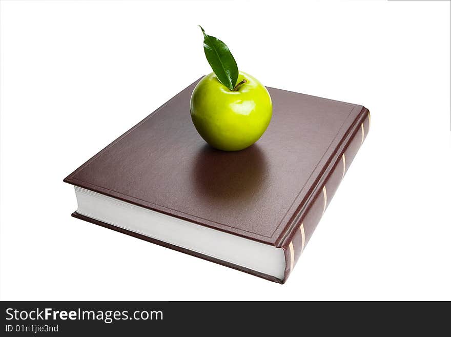 Book and green apple. White background