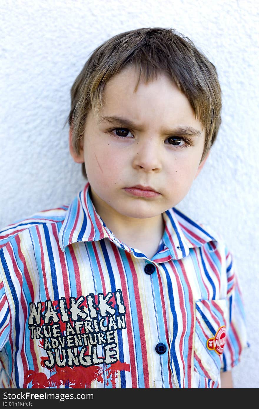 Serious looking portrait of a young boy. Intense, but very cute. Serious looking portrait of a young boy. Intense, but very cute.