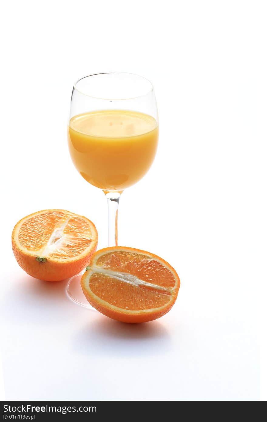 Orange lying near goblet of orange juice isolated on white background