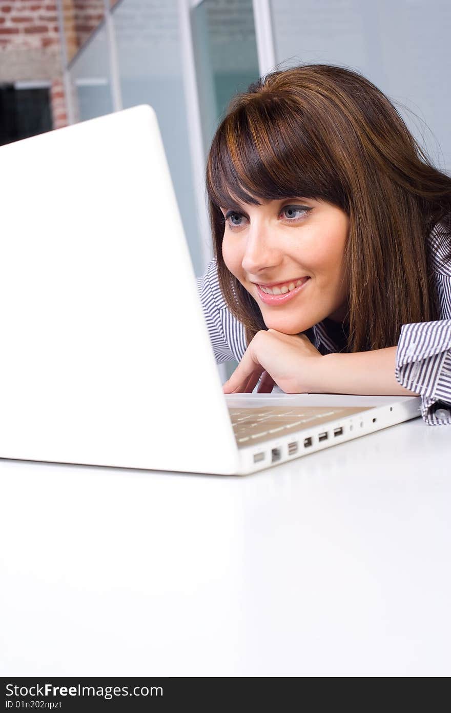 Business Woman on laptop in a modern loft office