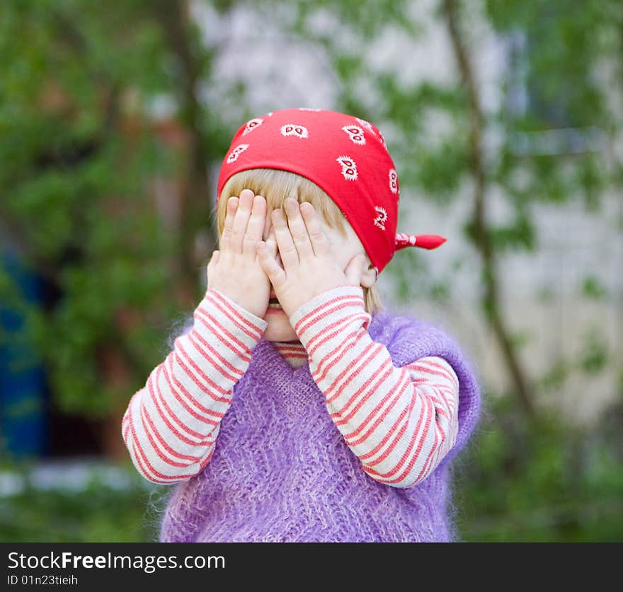 Young girl with her hands covering her eyes. Young girl with her hands covering her eyes.