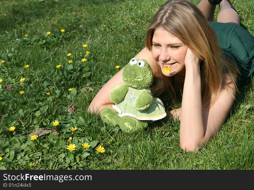 Funny girl with a toy frog