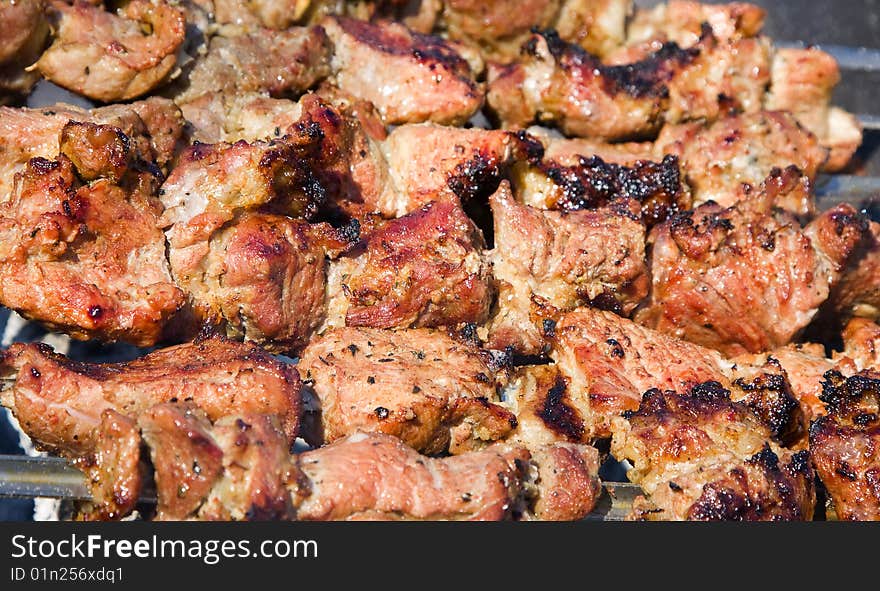 Shish kebab preparation on a brazier. Outdoor picnic.