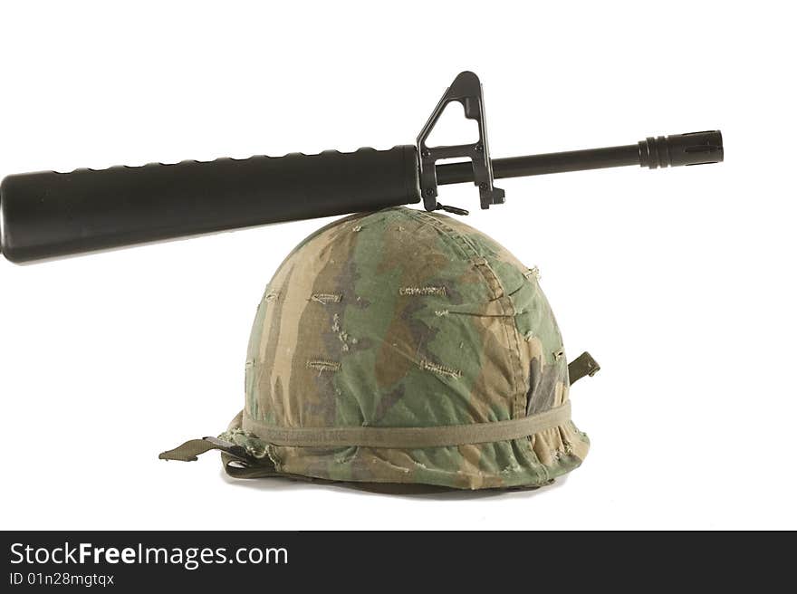 Vietnam helmet with an M16 rifle on a white background. Vietnam helmet with an M16 rifle on a white background