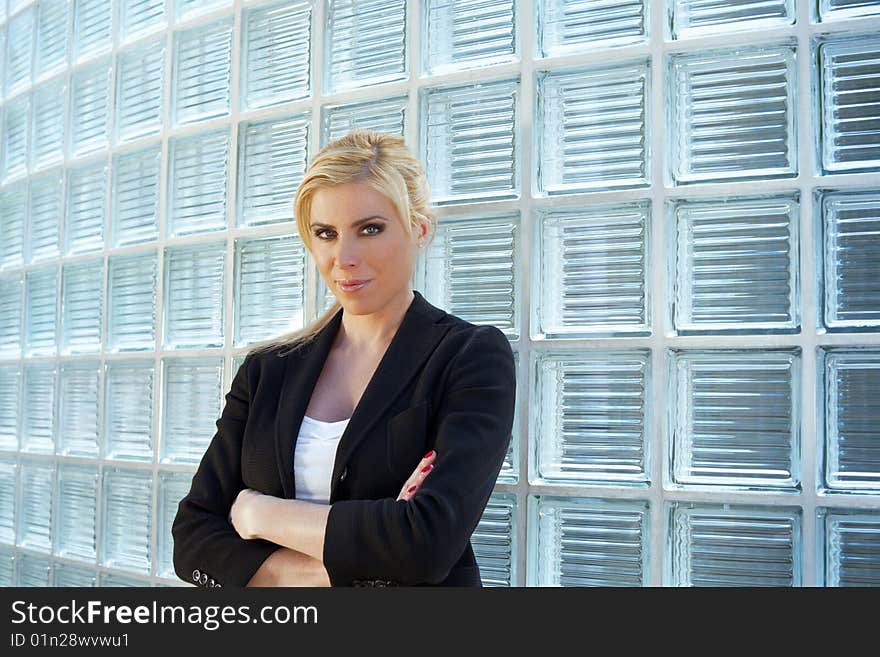 Portrait of blonde businesswoman with arms folded looking at camera. Copy space. Portrait of blonde businesswoman with arms folded looking at camera. Copy space