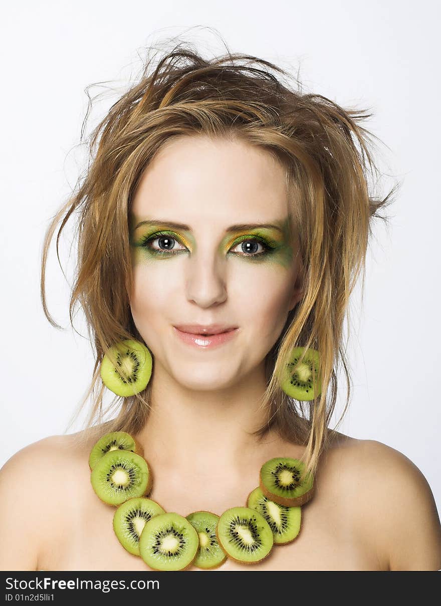 Portrait of young attractive woman with pieces of kiwi. Portrait of young attractive woman with pieces of kiwi