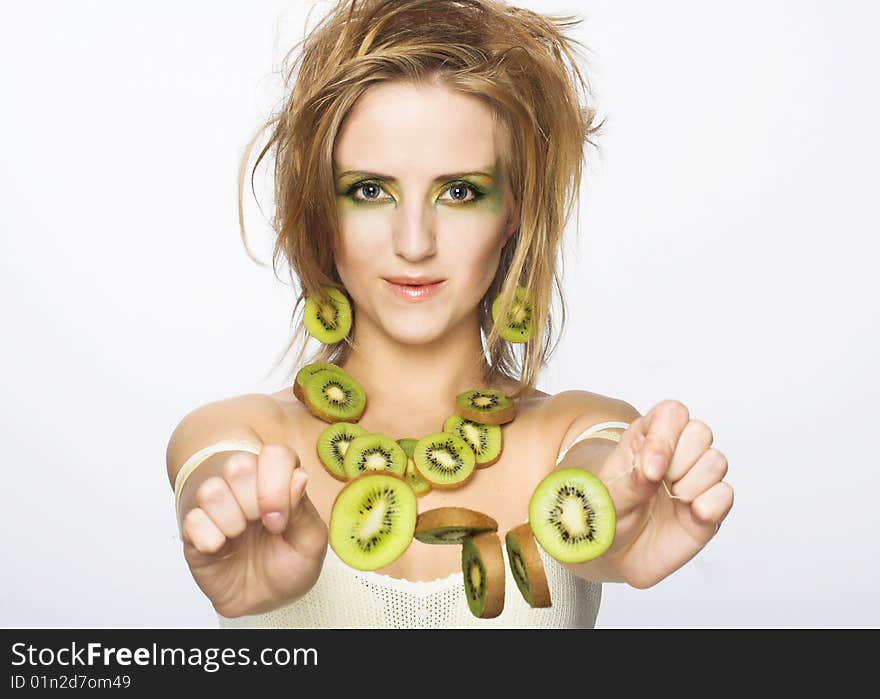 Portrait of young attractive woman with pieces of kiwi. Portrait of young attractive woman with pieces of kiwi