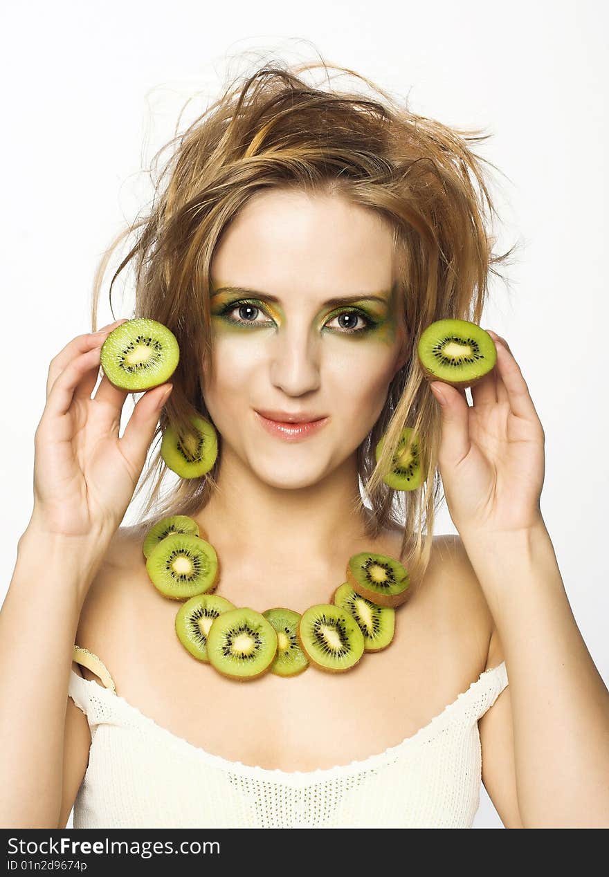 Portrait of young attractive woman with pieces of kiwi. Portrait of young attractive woman with pieces of kiwi