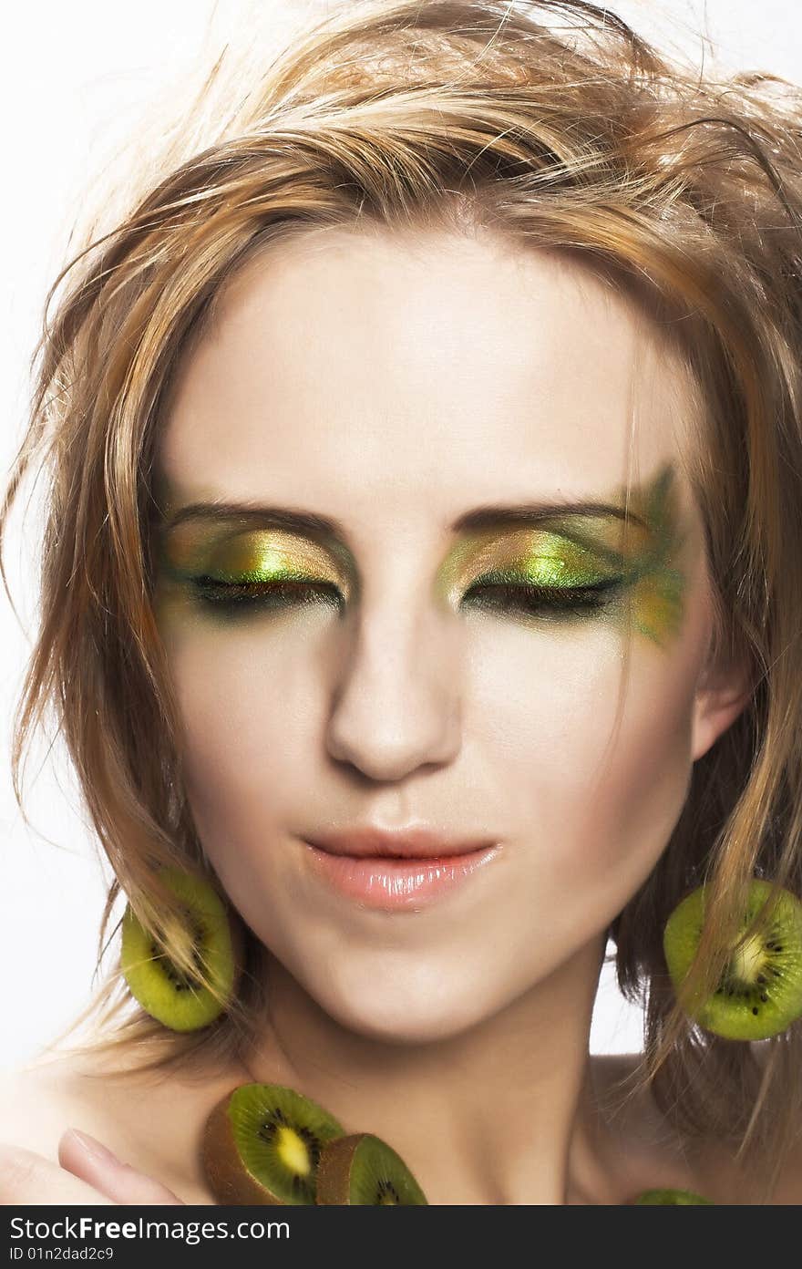 Portrait of young attractive woman with pieces of kiwi. Portrait of young attractive woman with pieces of kiwi