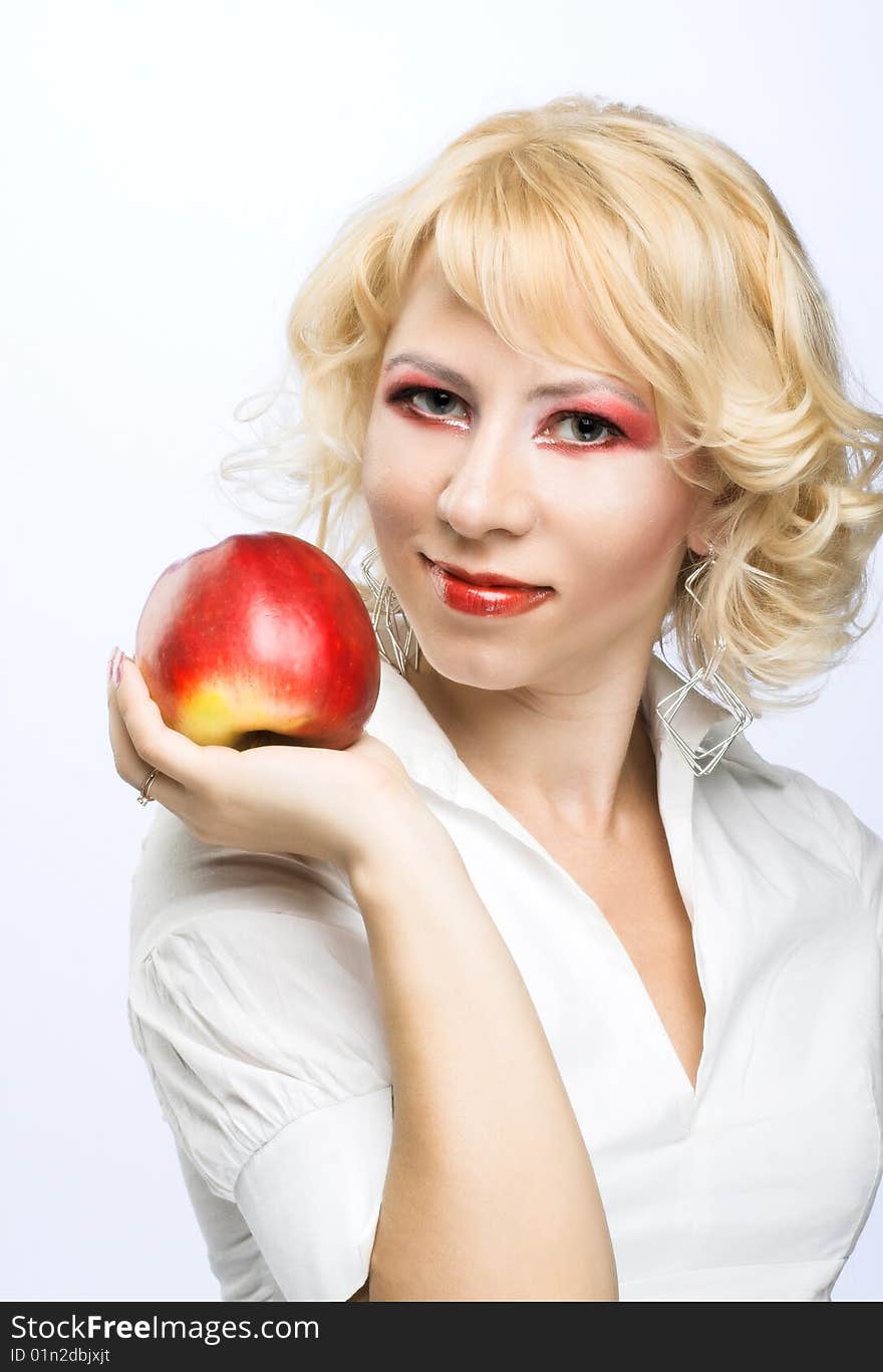 Portrait of young woman with red apple in her hand