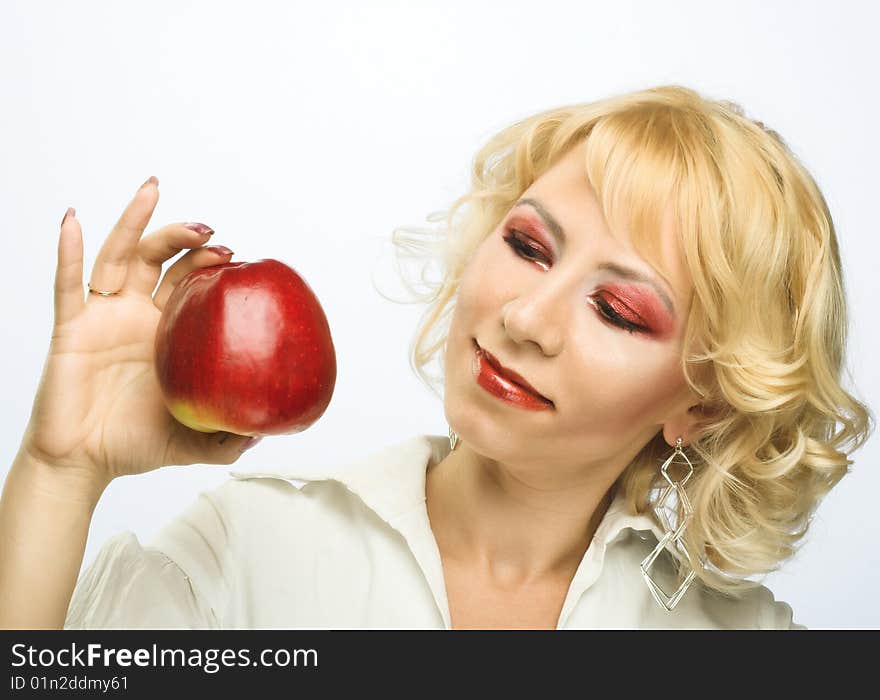 Portrait of young woman with red apple