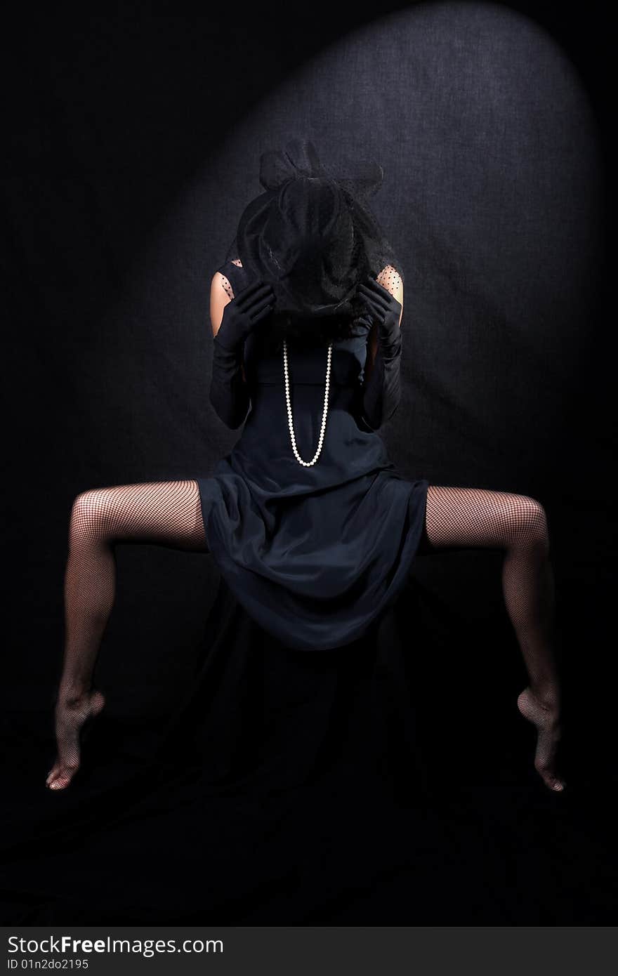 Girl with in hat with veil against black background. Girl with in hat with veil against black background