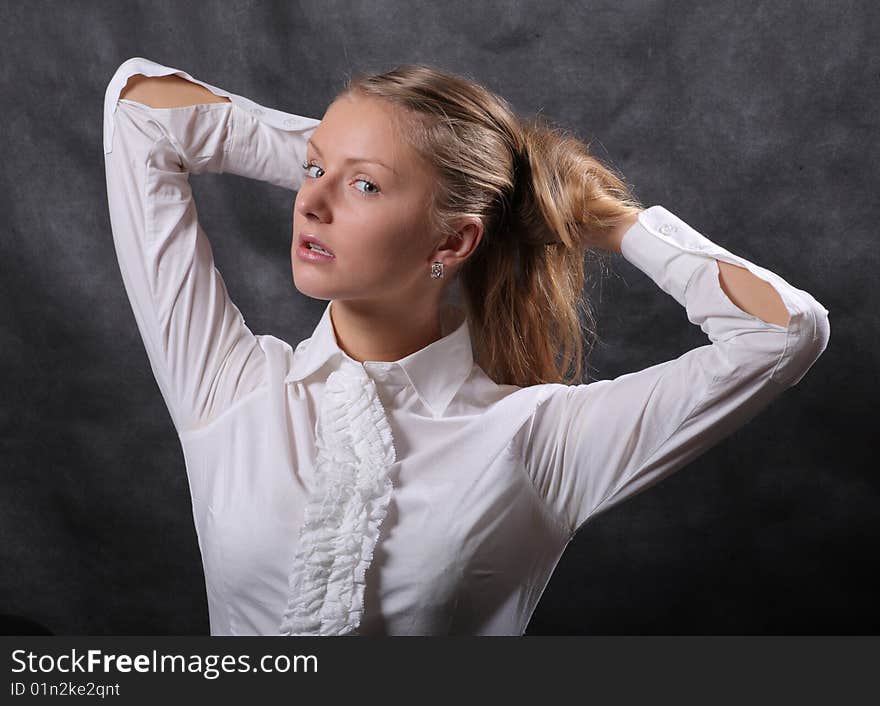 Woman in white lets her hair down. Woman in white lets her hair down