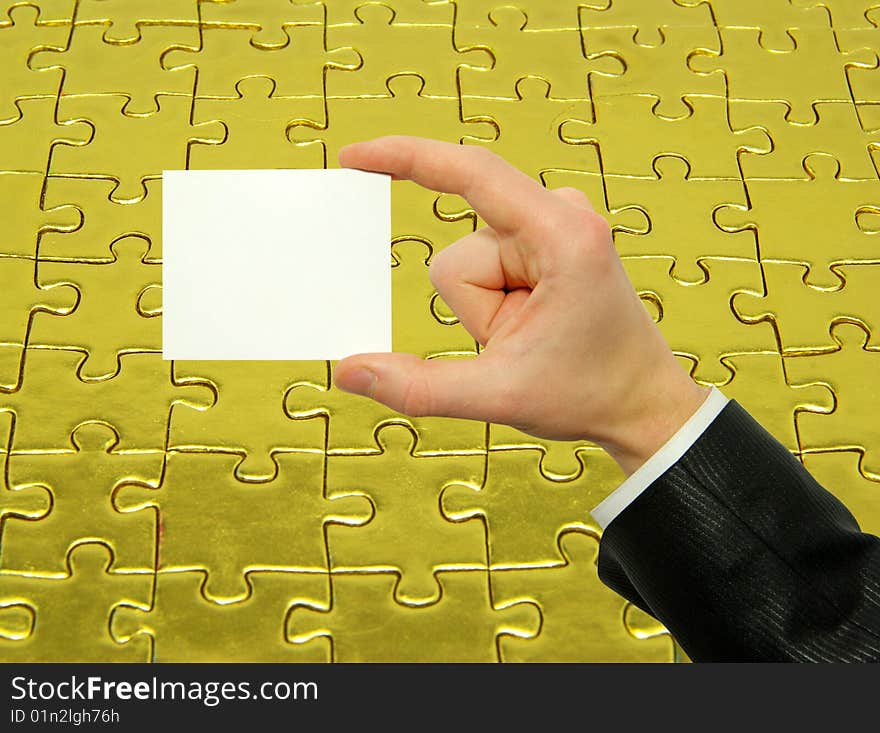 Blank card in hand isolated on gold background