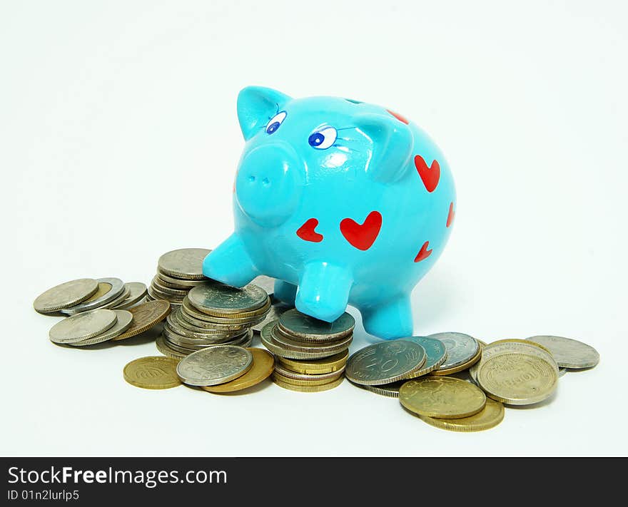 Piggy bank with golden coins, isolated on white.