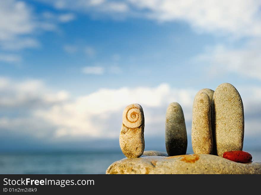 Oblong pebbles arranged vertically on the rock. Oblong pebbles arranged vertically on the rock