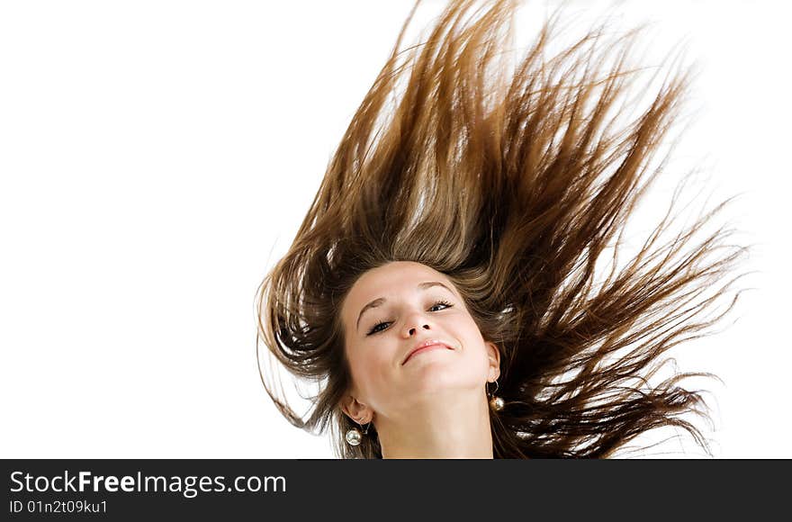 Fashion portrait of a young woman with hair lightly fluttering in the wind  on a white background. Fashion portrait of a young woman with hair lightly fluttering in the wind  on a white background