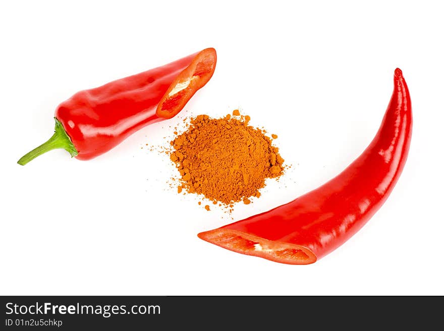 A composition of two pods of red hot pepper round a little of ground pepper on a white background. A composition of two pods of red hot pepper round a little of ground pepper on a white background