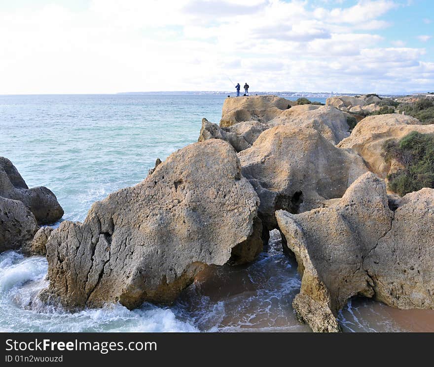 Two fishermen at the Atlantic coast by Albufeira. Two fishermen at the Atlantic coast by Albufeira