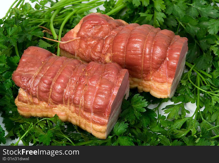 Sausage wares on a background greenery, studio shot