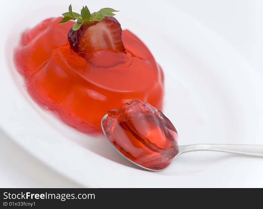 Strawberry dessert, half  berry and spoon on  white plate. Strawberry dessert, half  berry and spoon on  white plate