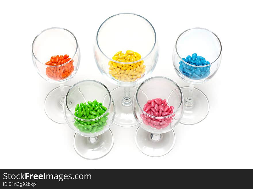 Transparent glasses with colour sweetmeat insulated on white background