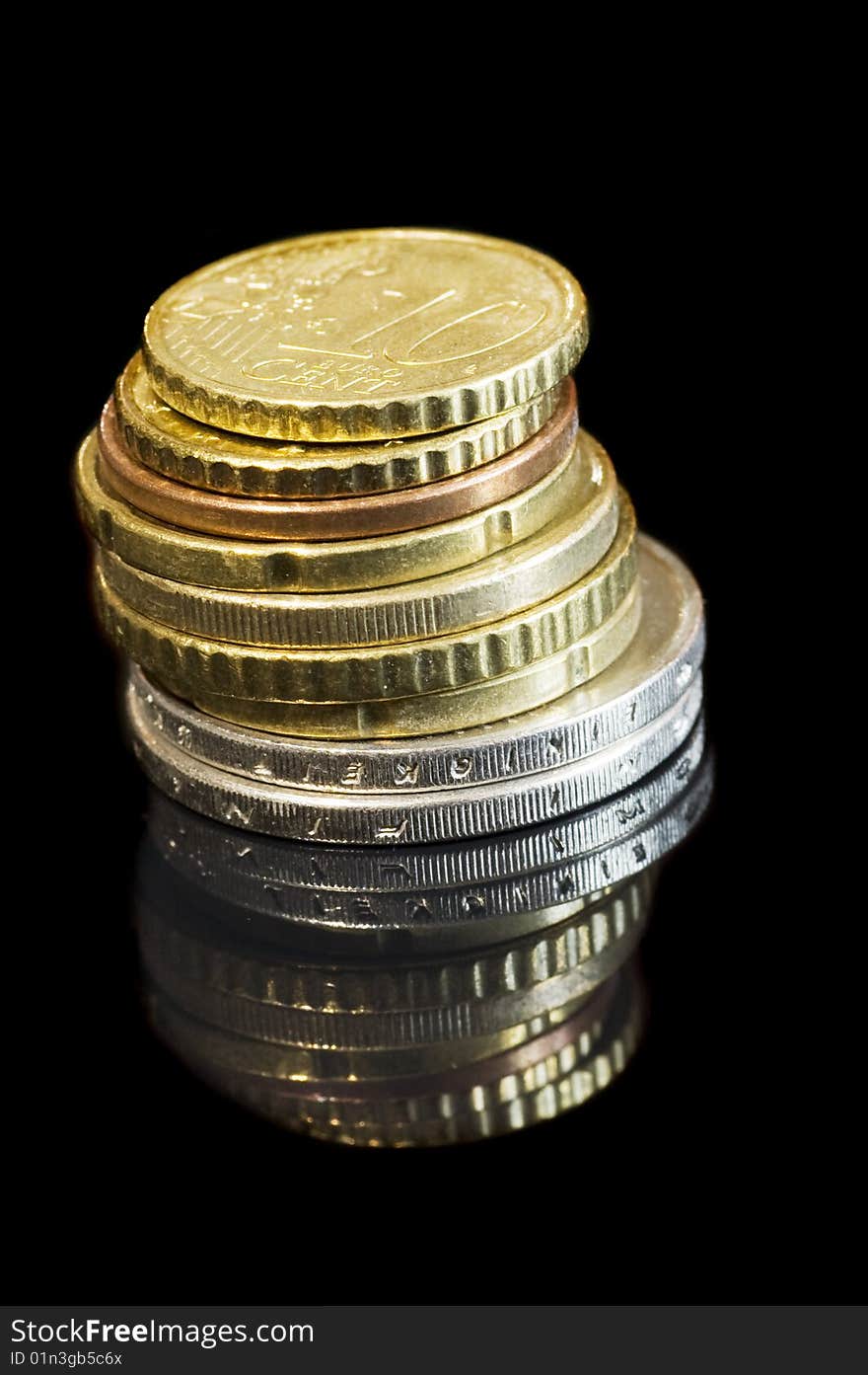 Stack of coins on black isolated