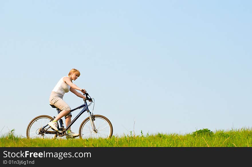 Girl relax biking on green grass