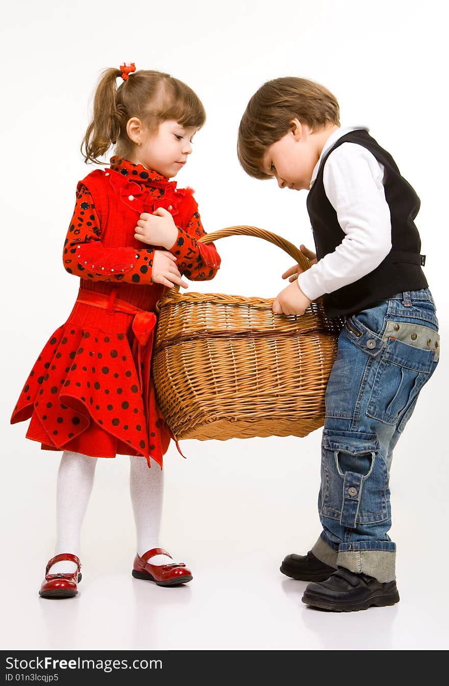 Two beautiful children with basket, isolated on white