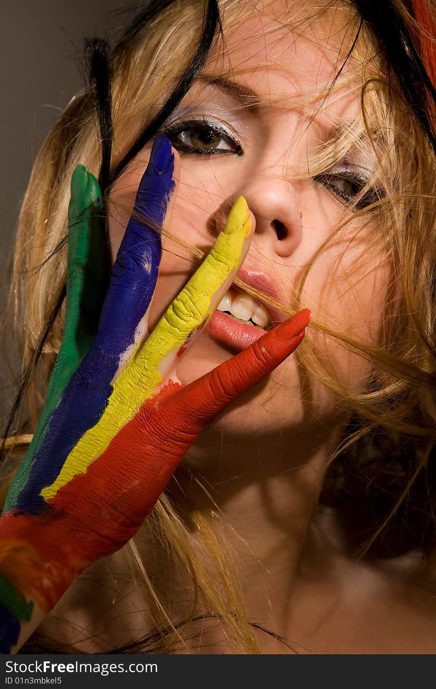 Pretty female model with hands painted rainbow style. Pretty female model with hands painted rainbow style