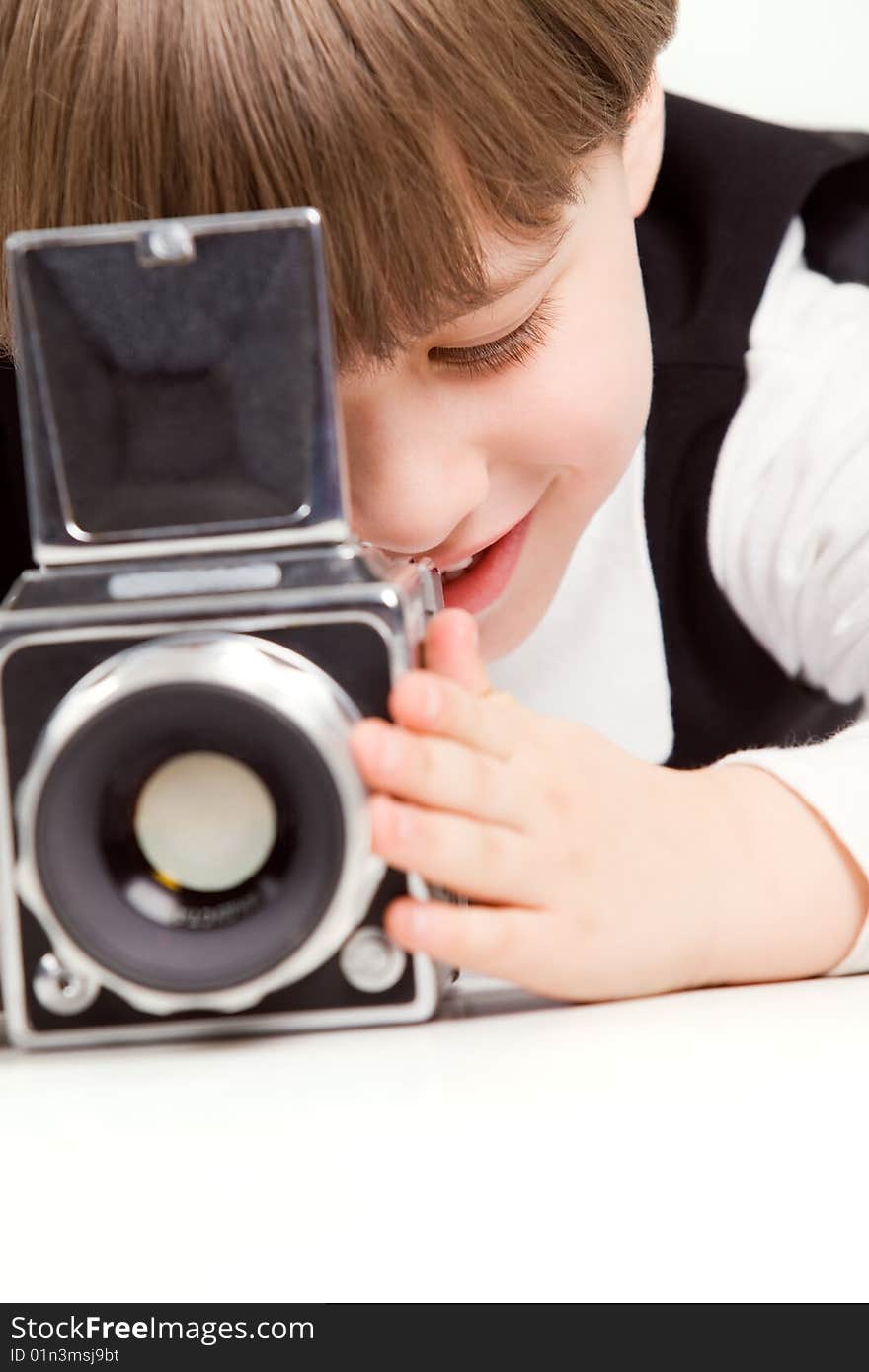 Attractive little boy with photo camera over white. Attractive little boy with photo camera over white